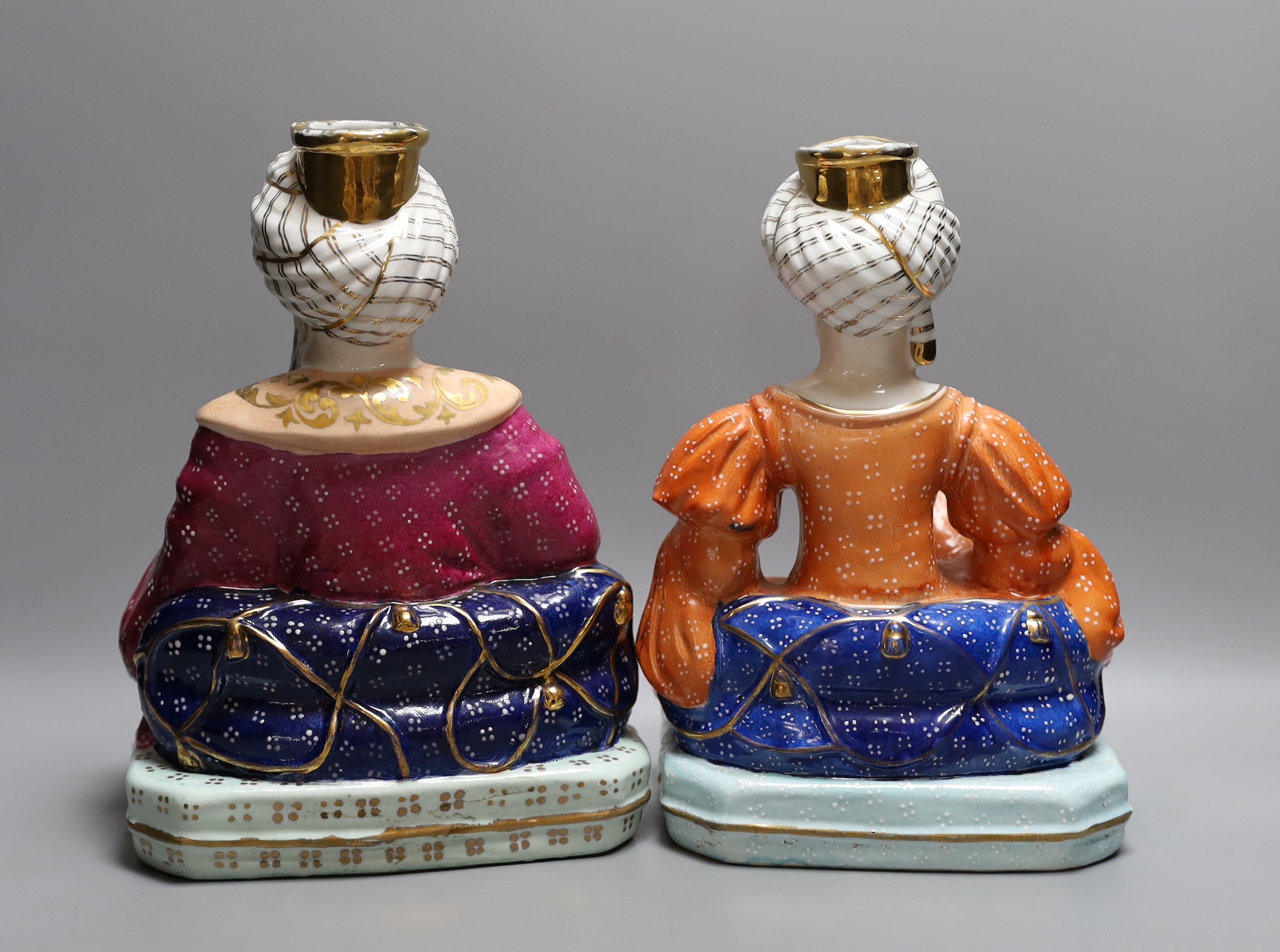 A pair of Jacob Petit style porcelain dressing table scent bottles, modelled as seated Turks, 26cm